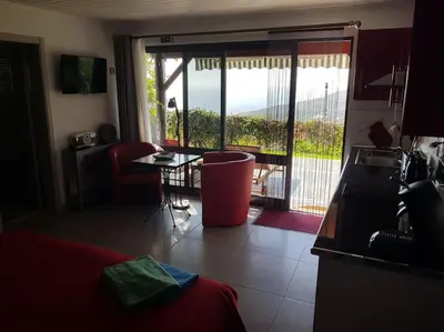 a room with a bed and a view of a balcony at Lucky Lemons - Boutique Houses Madeira (Studio) in Calheta