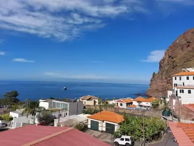 a city with the ocean in the background at Barbara Home in Madalena do Mar