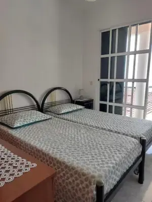 a bedroom with two beds and a window at Barbara Home in Madalena do Mar