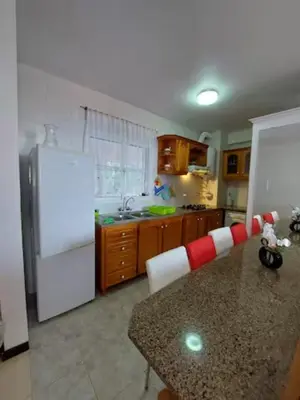 a kitchen with a white refrigerator and a counter top at Barbara Home in Madalena do Mar