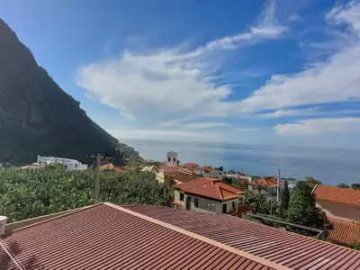 a view of a town with a mountain in the background at Barbara Home in Madalena do Mar