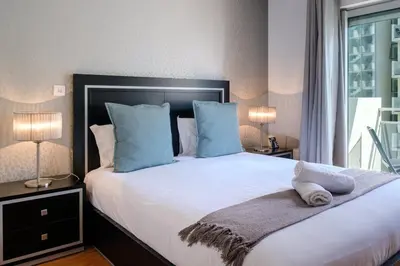 a bedroom with a large white bed with blue pillows at GuestReady - Scenic Retreat with Seaview in Funchal