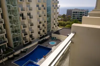 a view from the balcony of a building with a swimming pool at GuestReady - Scenic Retreat with Seaview in Funchal