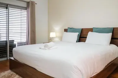 a bedroom with a large white bed with a window at GuestReady - Scenic Retreat with Seaview in Funchal