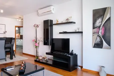 a living room with a flat screen tv on a wall at GuestReady - Scenic Retreat with Seaview in Funchal