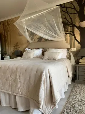 a bedroom with a white bed with a canopy at Villa Surga, a luxurious and exclusive romantic villa in the Algarve in Budens