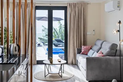 a living room with a couch and a table at Blue Ocean Villa in Ponta do Sol