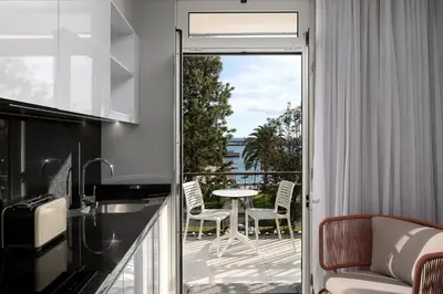 a kitchen with a balcony with a table and chairs at King David Suites by Homie in Funchal