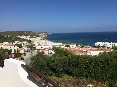 a view of a town with the ocean at Casa Panorama in Salema