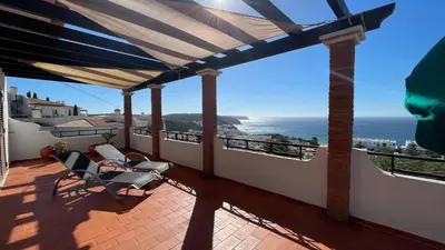 a balcony with chairs and a view of the ocean at Casa Panorama in Salema
