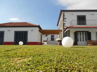 two large white balls on a yard in front of a house at Casa Pereira – Snooker, Wi-Fi, Bbq, Pool in Relógio do Poiso