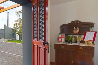 a red door leading into a room with a desk at Casa Pereira – Snooker, Wi-Fi, Bbq, Pool in Relógio do Poiso