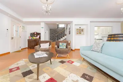 a living room with a blue couch and two chairs at Casa Pereira – Snooker, Wi-Fi, Bbq, Pool in Relógio do Poiso