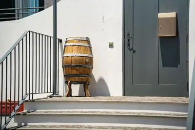 a wooden barrel sitting next to a door at Casa Pereira – Snooker, Wi-Fi, Bbq, Pool in Relógio do Poiso