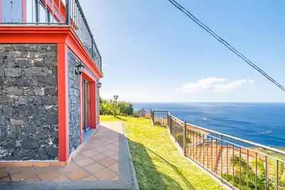 a building with a view of the ocean at Vila Brava Cottage in Ribeira Brava