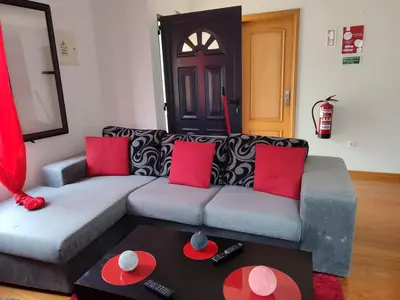 a living room with a couch and a table at Delfina`s House in Machico