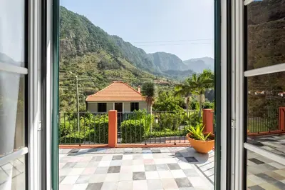 a view from the window of a house with mountains at Casa Grande da Camélia in São Vicente