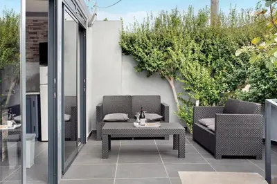 a patio with two chairs and a table at Sea La Vie House By Sam Houses in Ribeira Brava