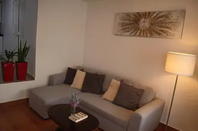 a living room with a couch and a table at Fifty's House 2 By Sam Houses in Ribeira Brava
