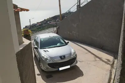 a silver car parked next to a wall at Fifty's House 2 By Sam Houses in Ribeira Brava
