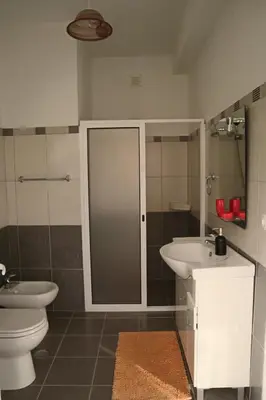 a bathroom with a toilet and a sink at Fifty's House 2 By Sam Houses in Ribeira Brava