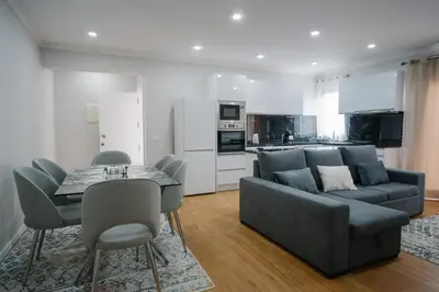 a living room with a couch and a table and chairs at casa são lourenço in Caniçal