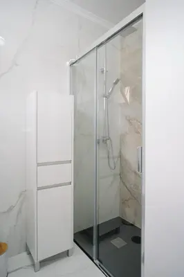 a shower with a glass door in a bathroom at casa são lourenço in Caniçal