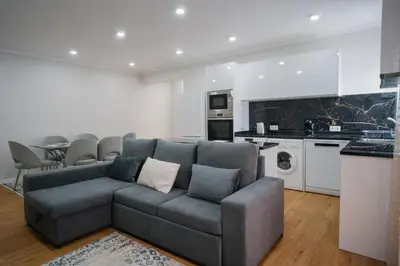 a living room with a couch and a kitchen at casa são lourenço in Caniçal