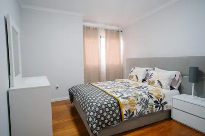 a bedroom with a bed and a window and a nightstand at casa são lourenço in Caniçal