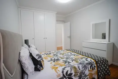 a bedroom with a bed with a floral blanket at casa são lourenço in Caniçal