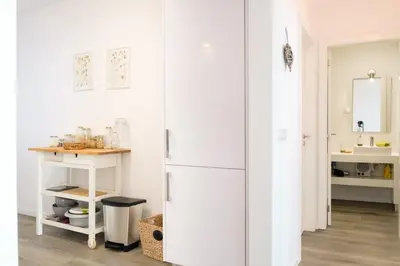 a kitchen with a white refrigerator and a sink at GuestReady - Cliff residence with sea views in Gaula