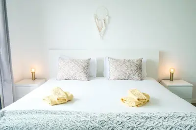 a white bed with two pillows on top of it at GuestReady - Cliff residence with sea views in Gaula