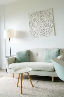 a living room with a couch and a table at GuestReady - Cliff residence with sea views in Gaula