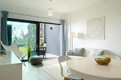 a white living room with a white table and chairs at GuestReady - Cliff residence with sea views in Gaula