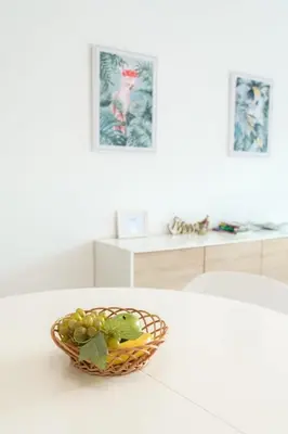 a bowl of fruit sitting on a white table at GuestReady - Cliff residence with sea views in Gaula