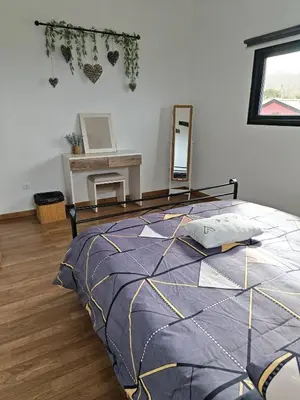 a bedroom with a bed and a mirror on the wall at Maravilha da Costa in Ponta do Pargo