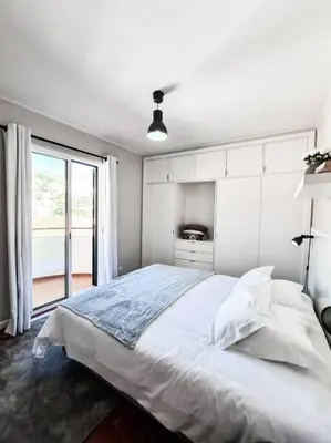 a white bedroom with a large bed and a window at Santa Luzia's Pearl III -Two Bedroom Apartment in Funchal