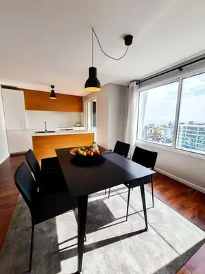 a dining room with a table and chairs and a kitchen at Santa Luzia's Pearl III -Two Bedroom Apartment in Funchal