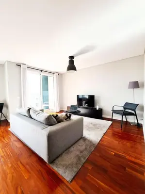 a white living room with a couch and a television at Santa Luzia's Pearl IV - Two bed Apartment in Funchal