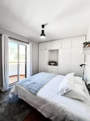 a white bedroom with a large bed and a window at Santa Luzia's Pearl IV - Two bed Apartment in Funchal