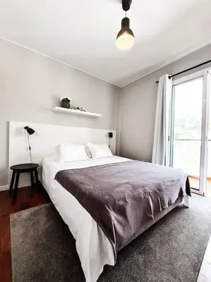a bedroom with a large bed and a window at Santa Luzia's Pearl IV - Two bed Apartment in Funchal