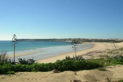 a sandy beach with the ocean in the background at Bonita Moradia c/ Piscina em SAGRES in Sagres