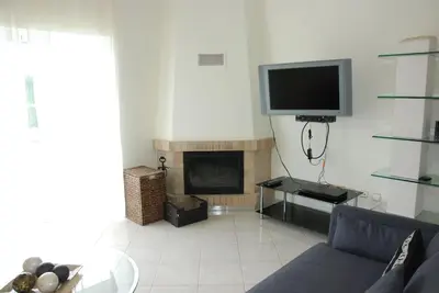 a living room with a couch and a tv at Bonita Moradia c/ Piscina em SAGRES in Sagres