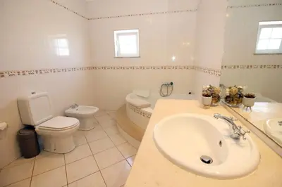 a bathroom with a sink and a toilet and a tub at Bonita Moradia c/ Piscina em SAGRES in Sagres