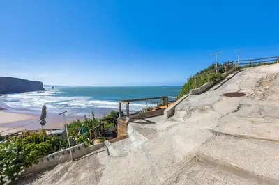 a set of stairs leading to the beach at Abrigo do Pescador in Aljezur