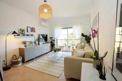 a living room with a couch and a table at B95 - Casa Melo Apartment in Praia da Luz in Luz
