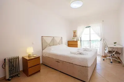 a bedroom with a bed and a desk and a window at B95 - Casa Melo Apartment in Praia da Luz in Luz