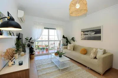 a living room with a couch and a table at B95 - Casa Melo Apartment in Praia da Luz in Luz