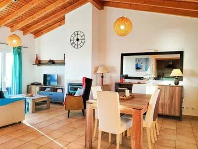 a kitchen and living room with a table and chairs at Varandas Guest Apartment in Aljezur