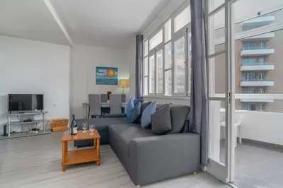 a living room with a couch and a table at Duas Torres View Apartment in Funchal